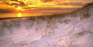 winter beach sunset with snow